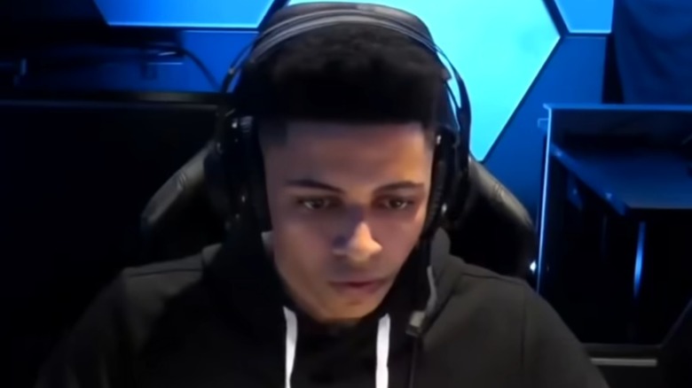 Myth sitting in gaming chair playing Fortnite