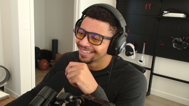 Myth wearing headphones and talking into a microphone