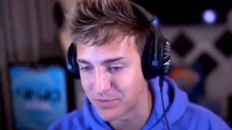 Ninja wearing headphones and looking at computer monitor