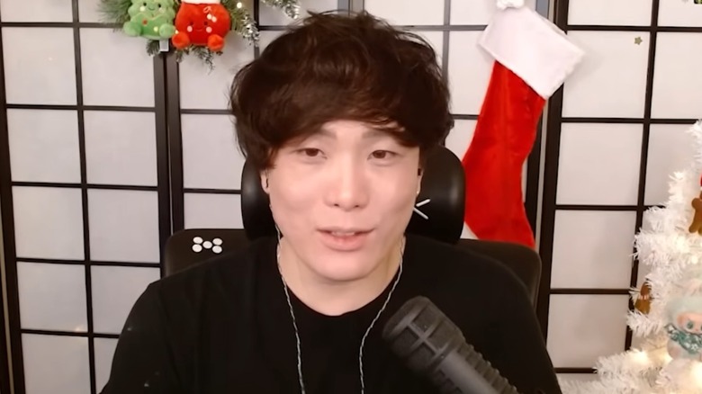 Sykkuno talking into mic in front of Christmas decorations
