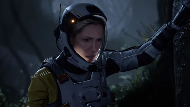 Selene leans on tree