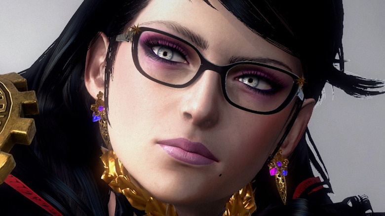 Bayonetta 3's Bayonetta examining a mysterious object