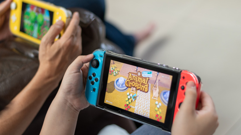Two people playing Nintendo Switch