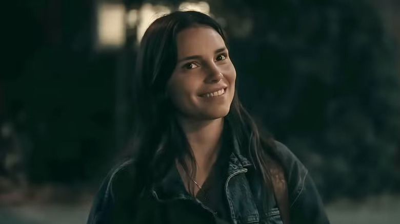 Nikki Freeman smiles in front of her house in "Obsession" (2026)