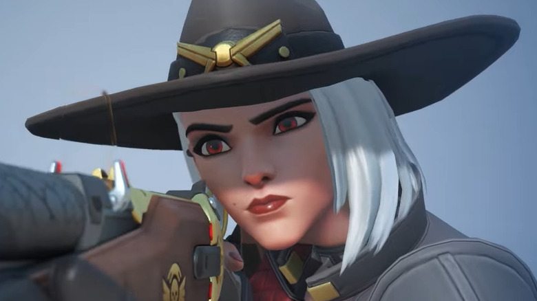 Overwatch 2's Ashe staring down her weapon, The Viper, during a highlight intro