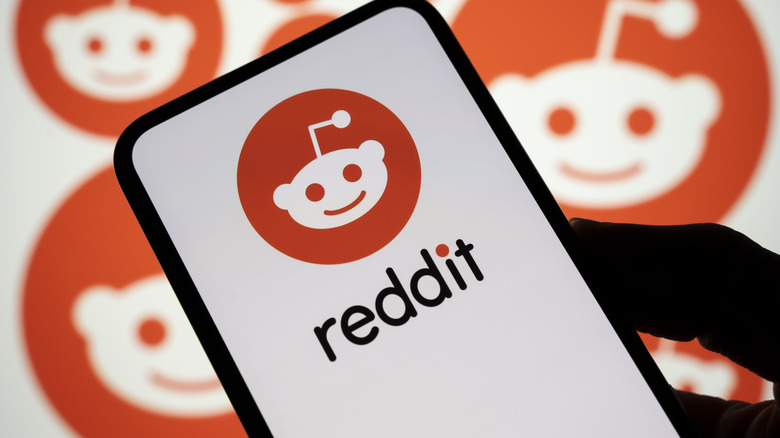 A phone showcasing the Reddit logo