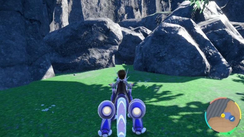 Trainer riding Miraidon in Area Zero