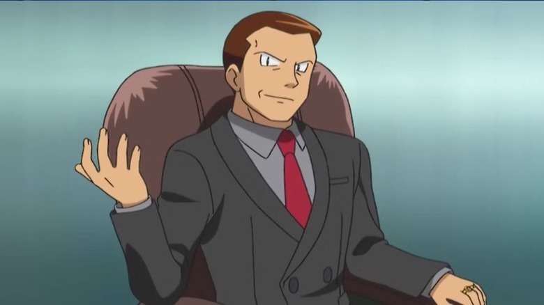 Giovanni gesturing in chair