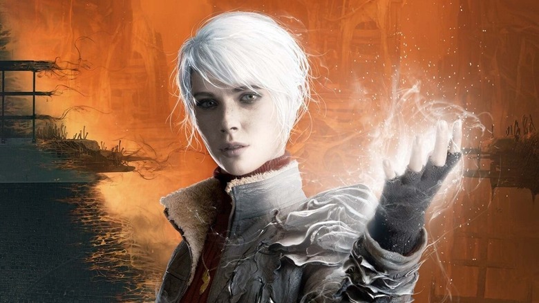 Marianne raises a glowing hand on the cover art for The Medium