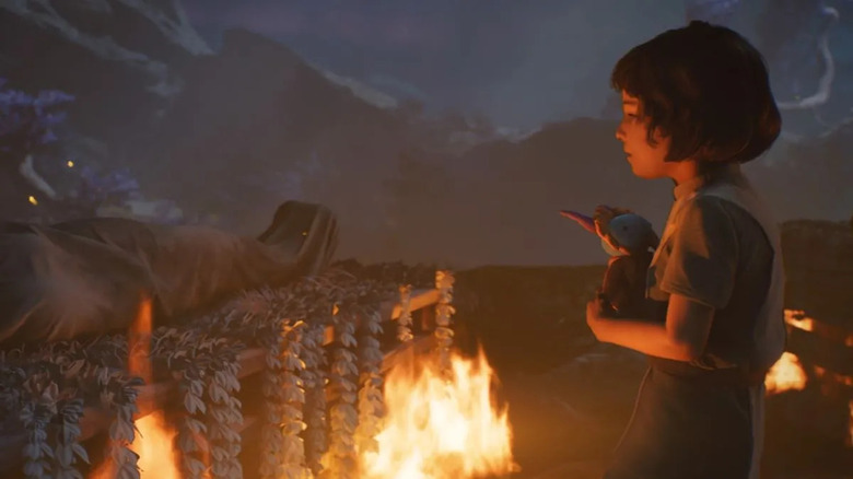 Kata standing next to pyre