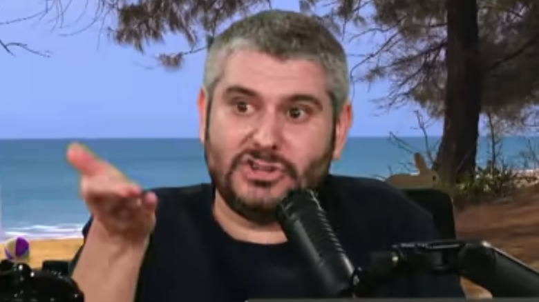 Ethan Klein gesturing in front of microphone
