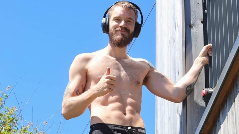 PewDiePie shirtless and giving a thumbs up