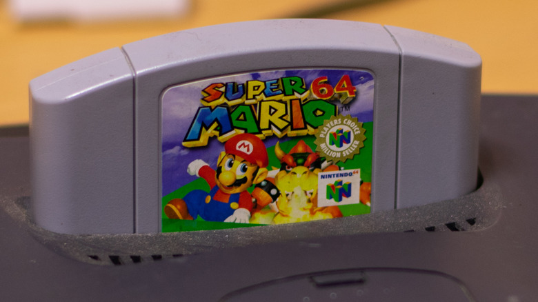 Mario 64 cartridge in console