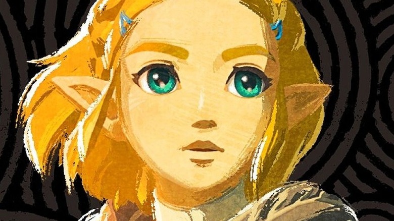 Zelda holding a torch in a cave