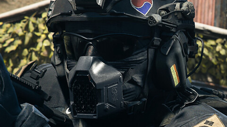 Helmeted Warzone operator aiming gun