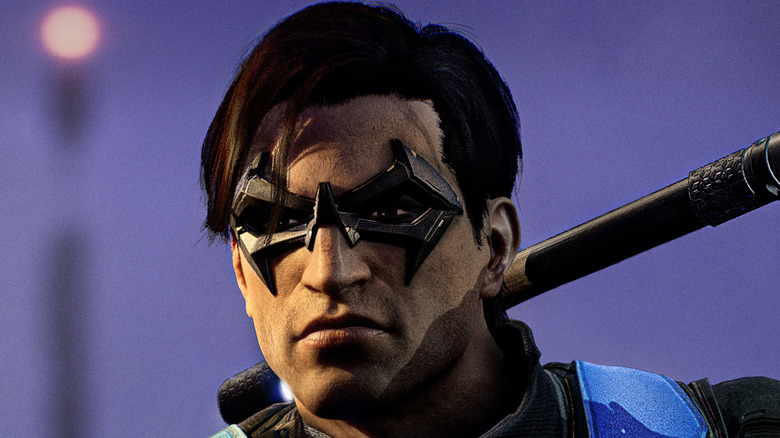 Nightwing scowling with weapon