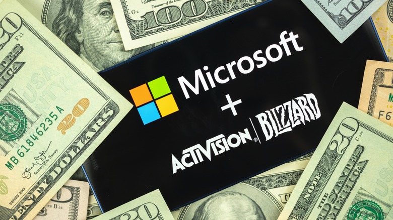 Microsoft and Activison Blizzard logos covered with money