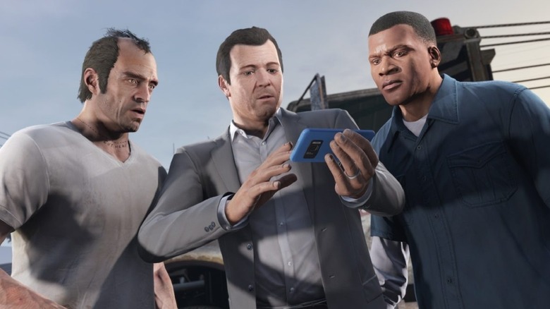 Trevor, Michael, and Franklin looking at a phone in Grand Theft Auto V (2013)