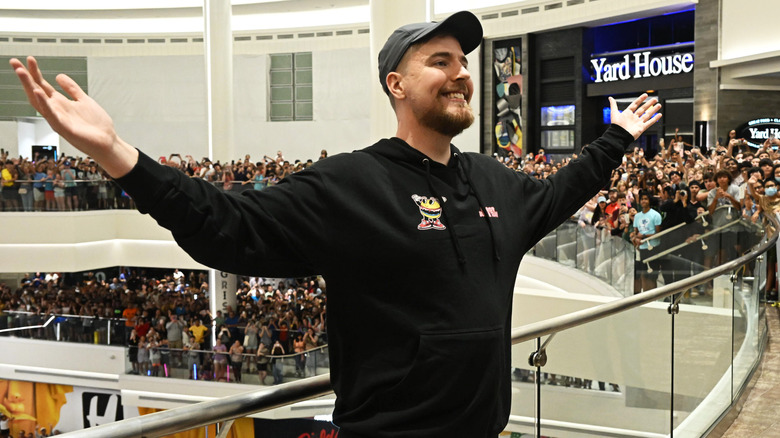 MrBeast arms raised in convention center
