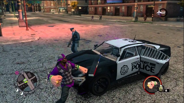 A man punches a police car