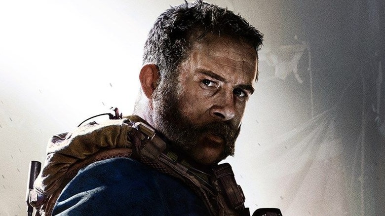 Soldier in a vest glares at the screen in "Call of Duty: Warzone"