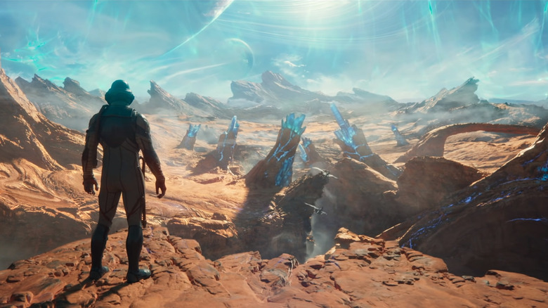 man in space suit gazing across landscape