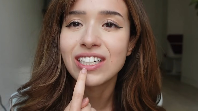 Pokimane pointing at teeth