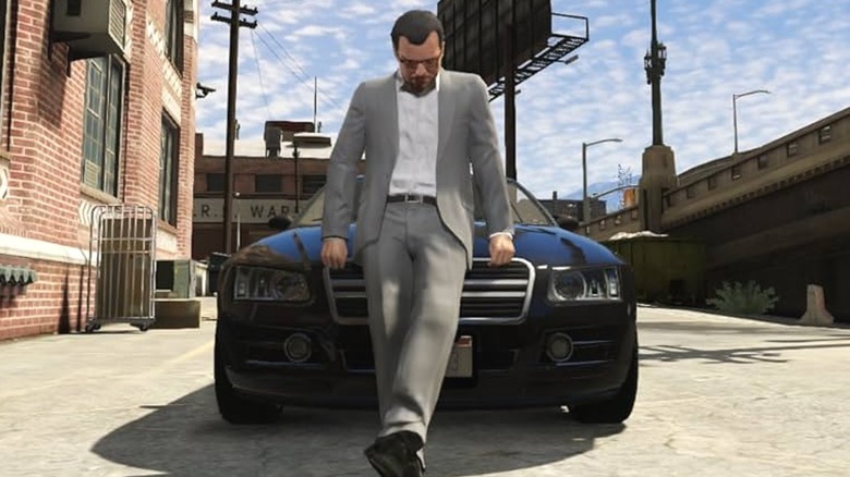 Michael sits on car