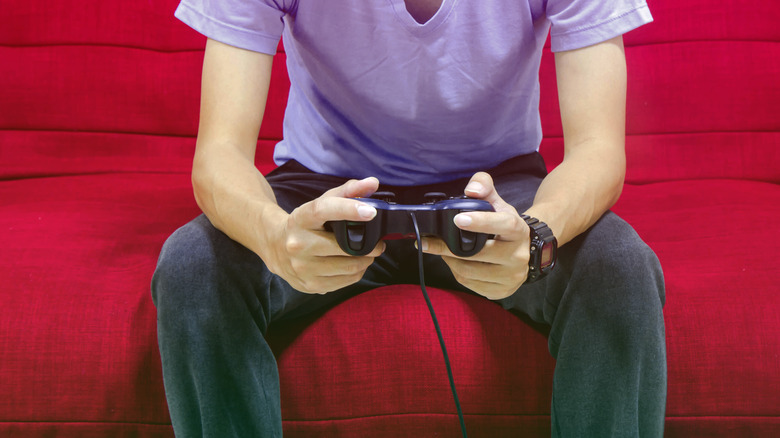 person holding video game controller
