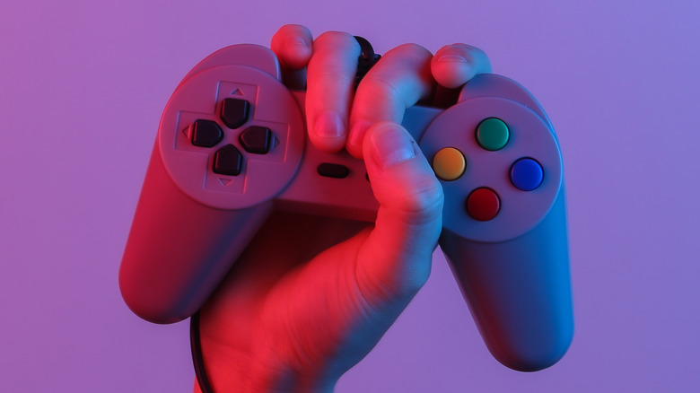 Hand holding PS1 controller