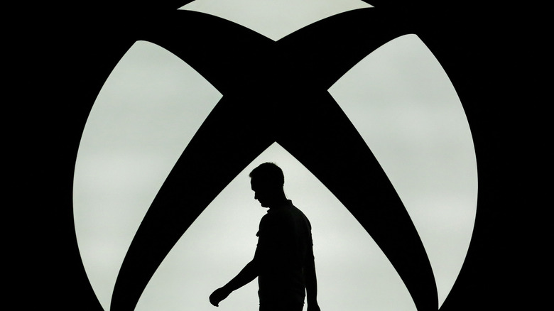silhouette in front of Xbox logo