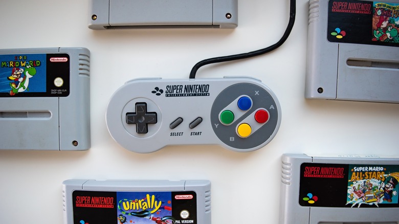 SNES controller surrounded by games
