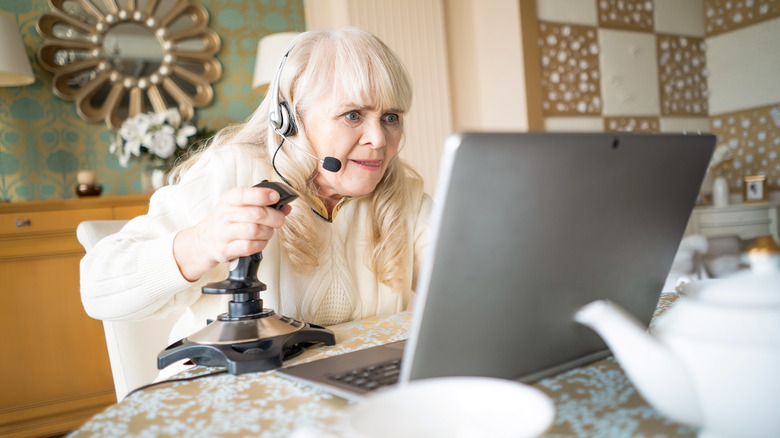 Old woman playing video games