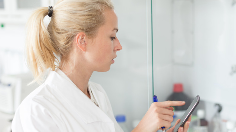 Scientist looking through microscope 