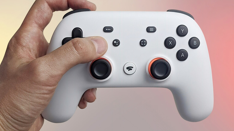 Person holding Google Stadia controller