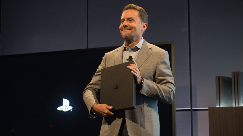 Former Sony CEO Andrew House holding a PlayStation 4
