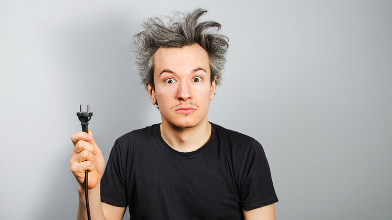 Guy holding plug