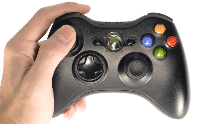 Hand holding Xbox 360 controller