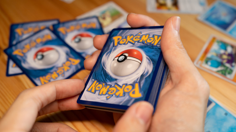 Hand holding Pokemon deck
