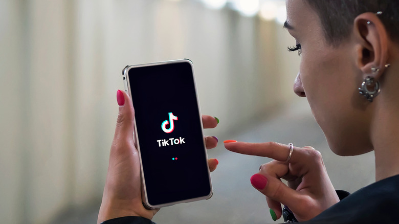 Woman looking at TikTok on her phone