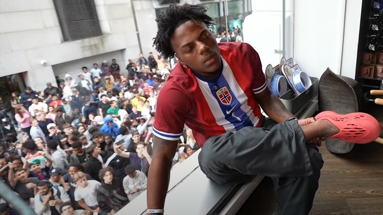 IShowSpeed holding his injured ankle in Norway