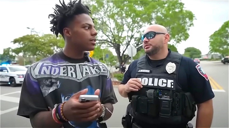 Two police officers talking to IShowSpeed