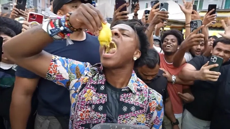 IShowSpeed eating fruit in Malaysia surrounded by fans
