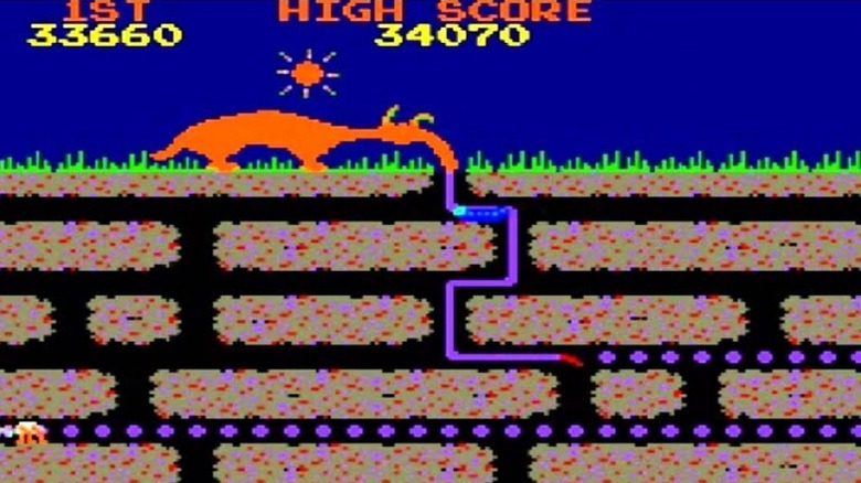 An anteater sticks their purple tongue into a tunnel in Anteater