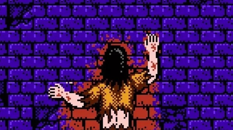 A bloody character laying on cobbles in Sweet Home