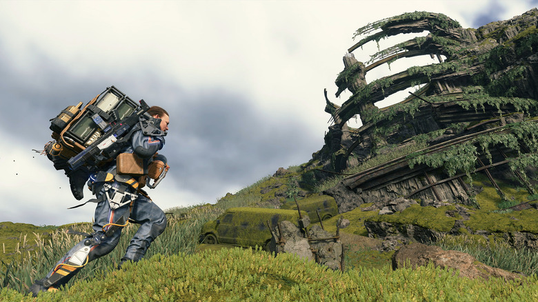 Sam carrying packages near ruins