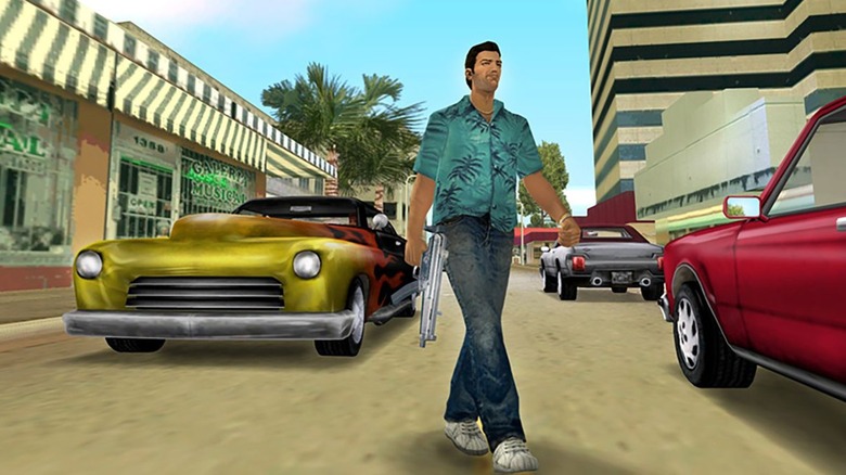 Tommy walking between cars with gun