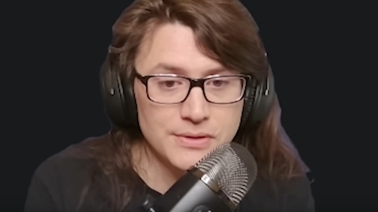Pirate Software talks into microphone on a gray background