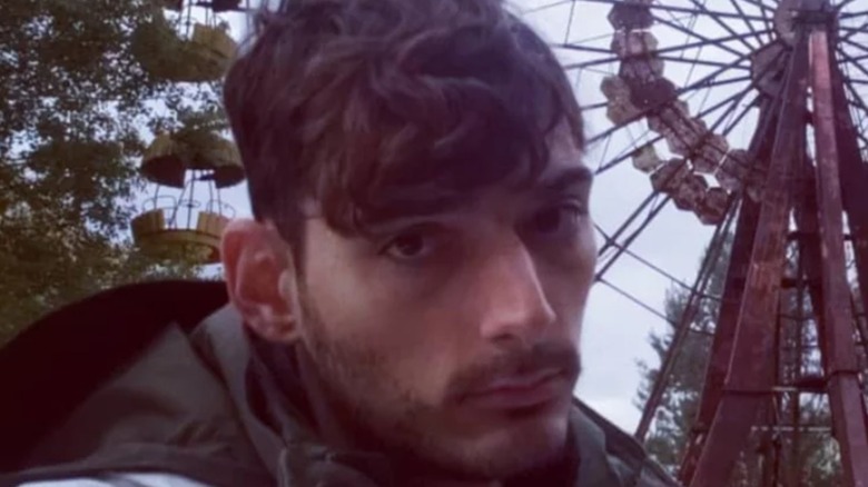 Ice Poseidon taking selfie in front of ferris wheel