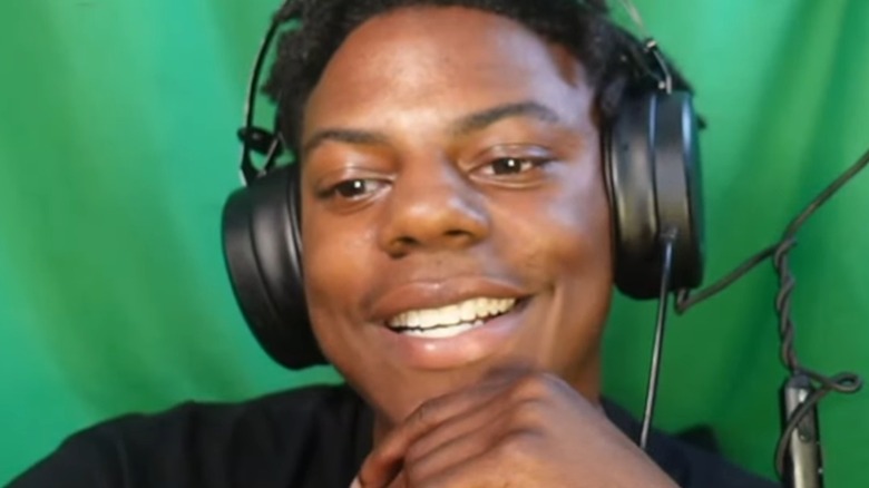 IShowSpeed wearing headphones in front of green screen